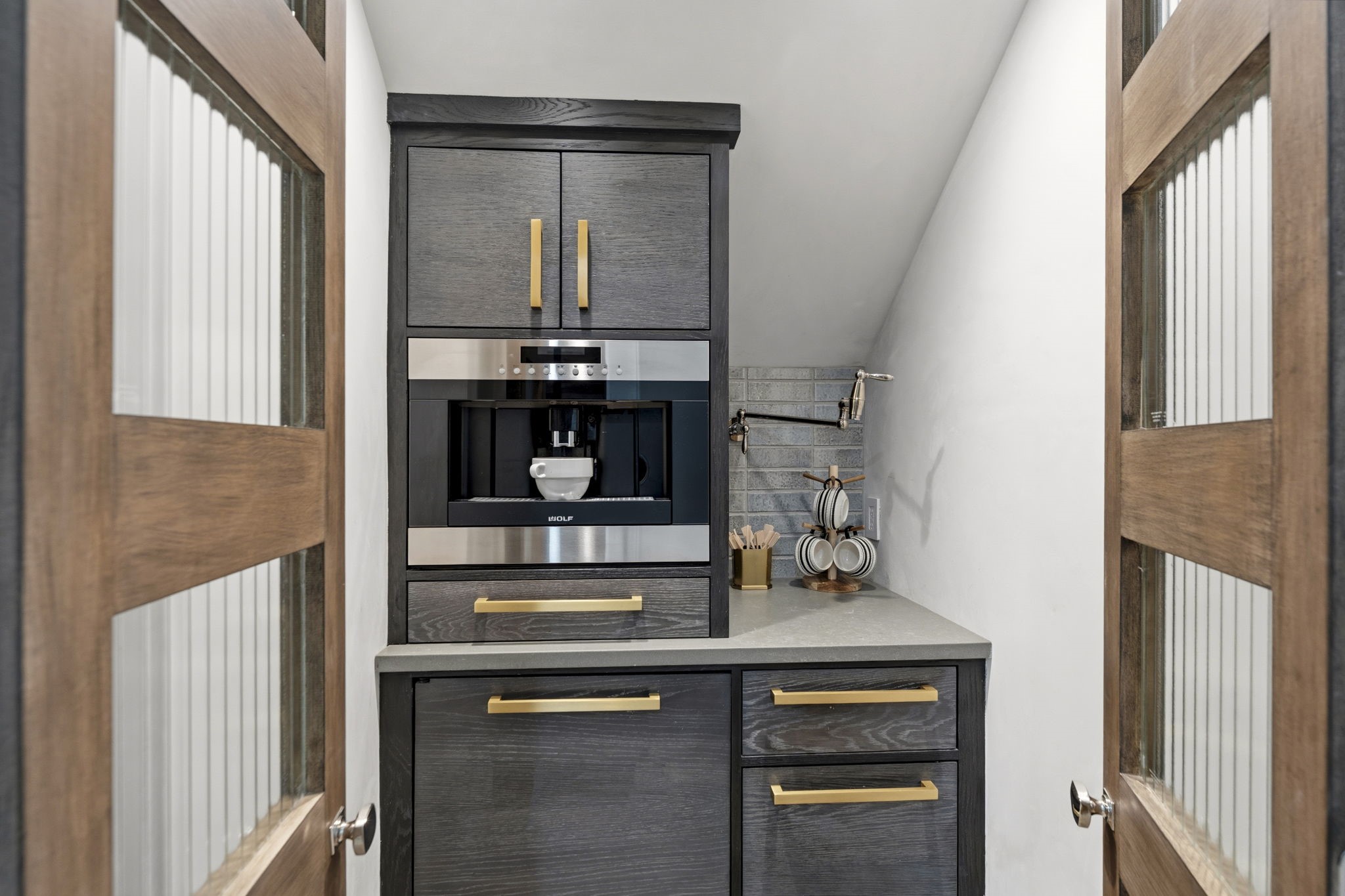 27006 Star Gazer Way Spring, TX 77386 - Photo 18 of 50 Custom details shine with safety glass sliding barn-style pantry doors, handcrafted Ken Mason tile, and thoughtfully designed storage solutions throughout this sophisticated prep space.