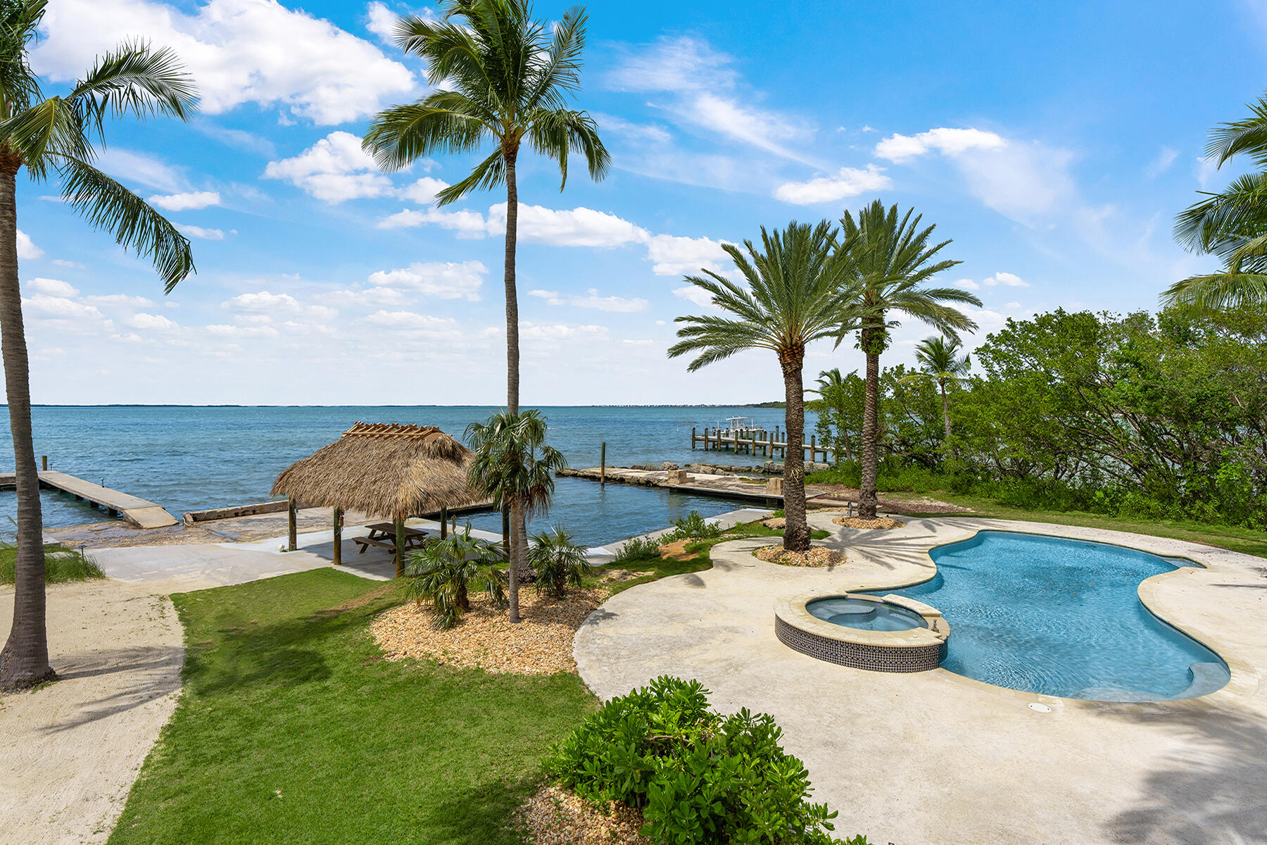 36 Sunset Road Key Largo, FL 33037 - Photo 3 of 25 a view of a swimming pool with a table and chairs
