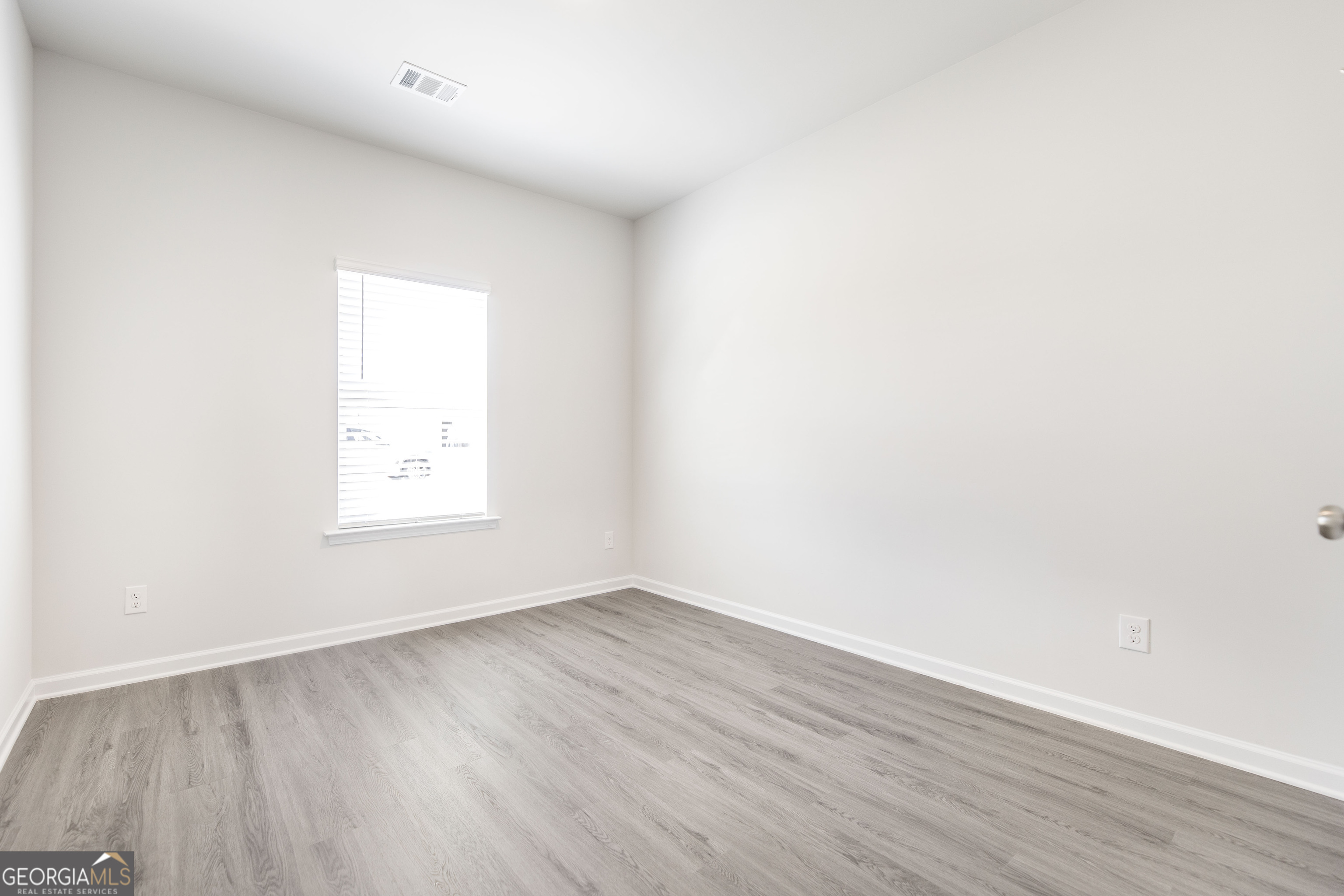 508 Georgian Walk Byron, GA 31008 - Photo 24 of 27 an empty room with wooden floor and windows