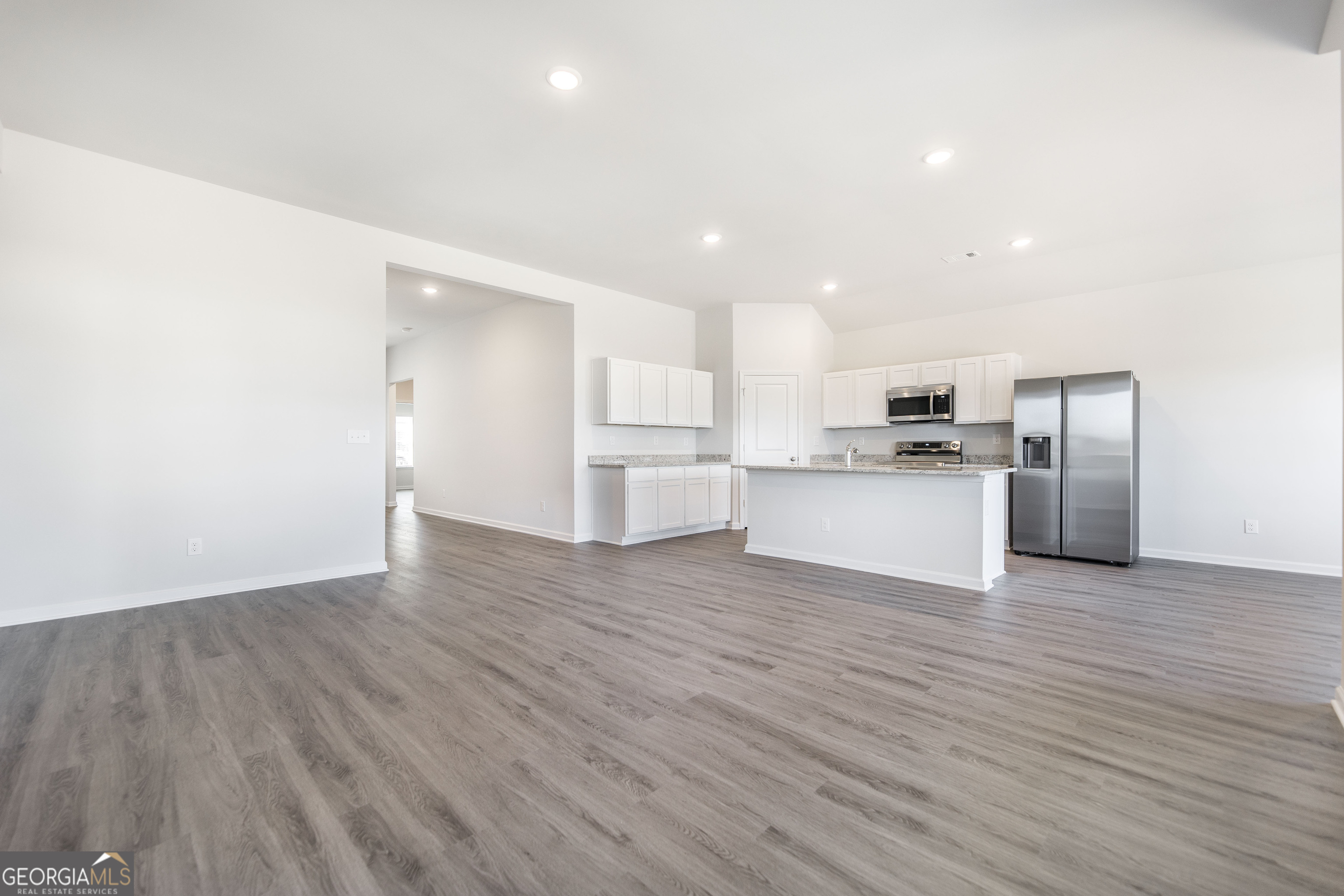 508 Georgian Walk Byron, GA 31008 - Photo 3 of 27 a view of a kitchen with wooden floor electronic appliances and window