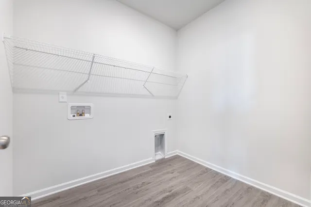 a view of a room with wooden floor