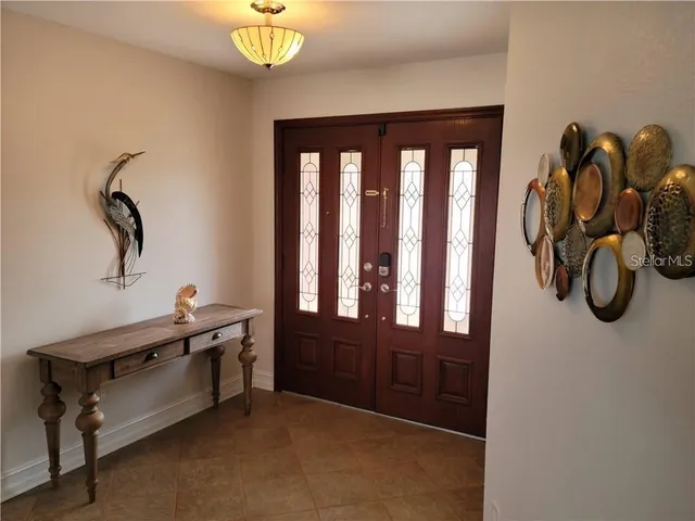 a living room with furniture and painting on the wall