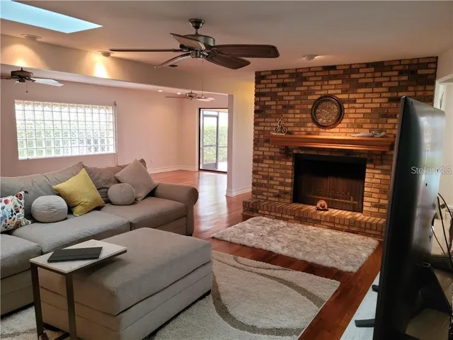 a kitchen with stainless steel appliances granite countertop sink stove top oven table and chairs