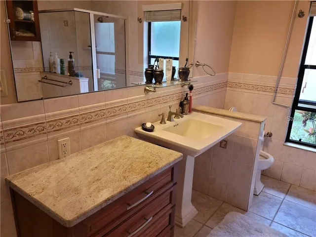 a bathroom with a sink a mirror and a bathtub