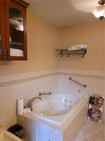 a bathroom with a granite countertop sink and a toilet