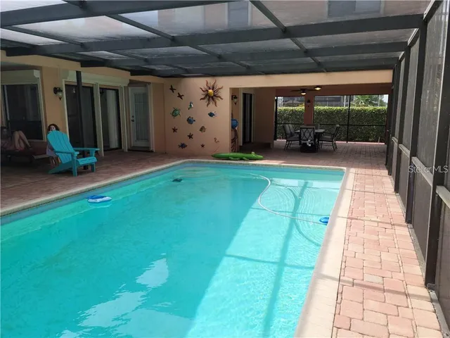 a view of a porch with furniture and a yard