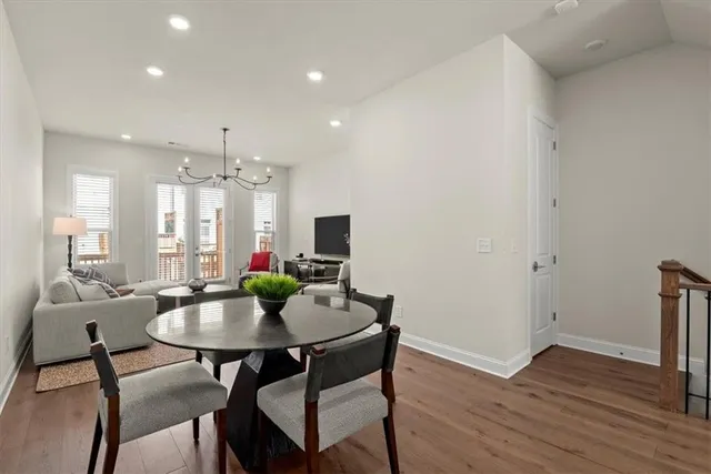 a view of a dining room with furniture and wooden floor