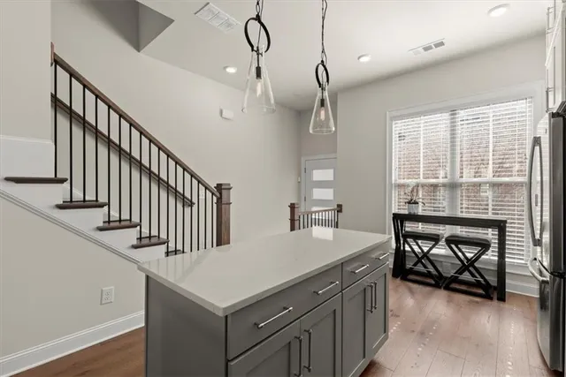 a kitchen with a stove a sink a dining table and chairs