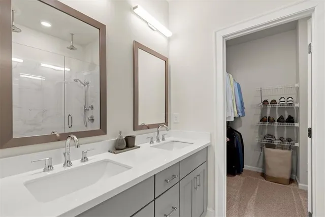 a bathroom with a double vanity sink a and a mirror