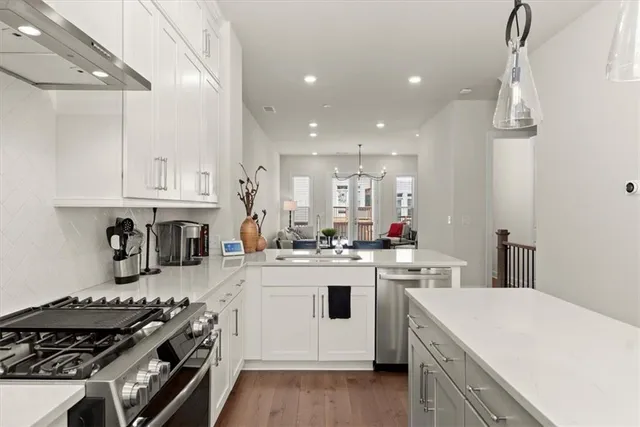 a kitchen with a white stove top oven sink and cabinets