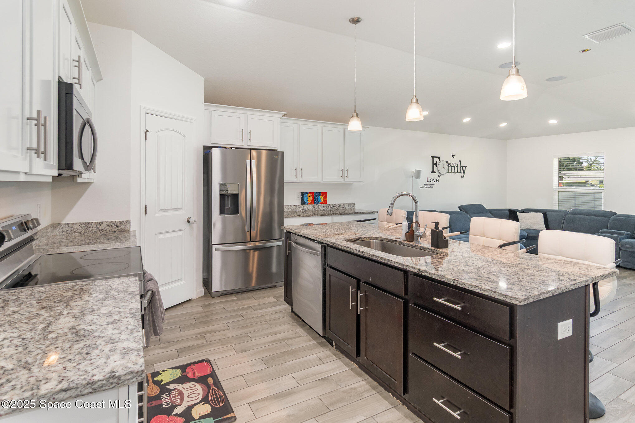1534 Pine Street Orlando, FL 32824 - Photo 12 of 31 a kitchen with stainless steel appliances granite countertop a sink refrigerator and cabinets