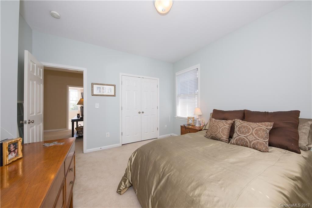 607 Caspar Way Fort Mill, SC 29708 - Photo 12 of 24 a bedroom with a bed and a couch