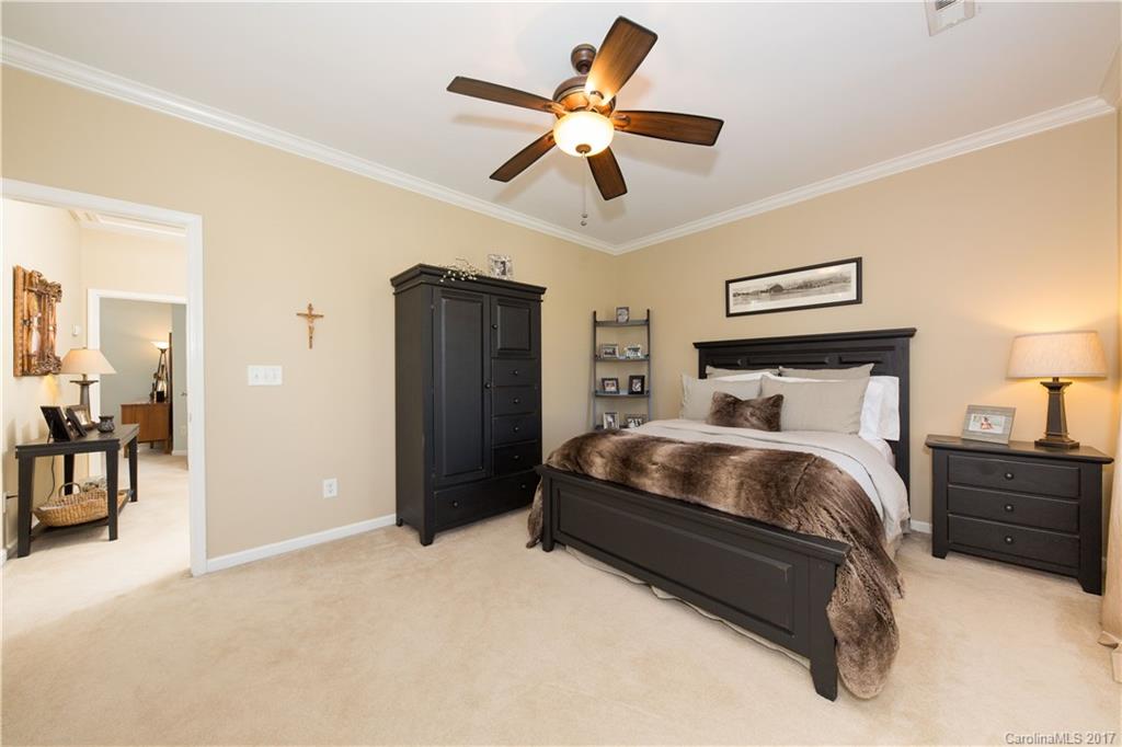 607 Caspar Way Fort Mill, SC 29708 - Photo 16 of 24 a bedroom with a bed and ceiling fan