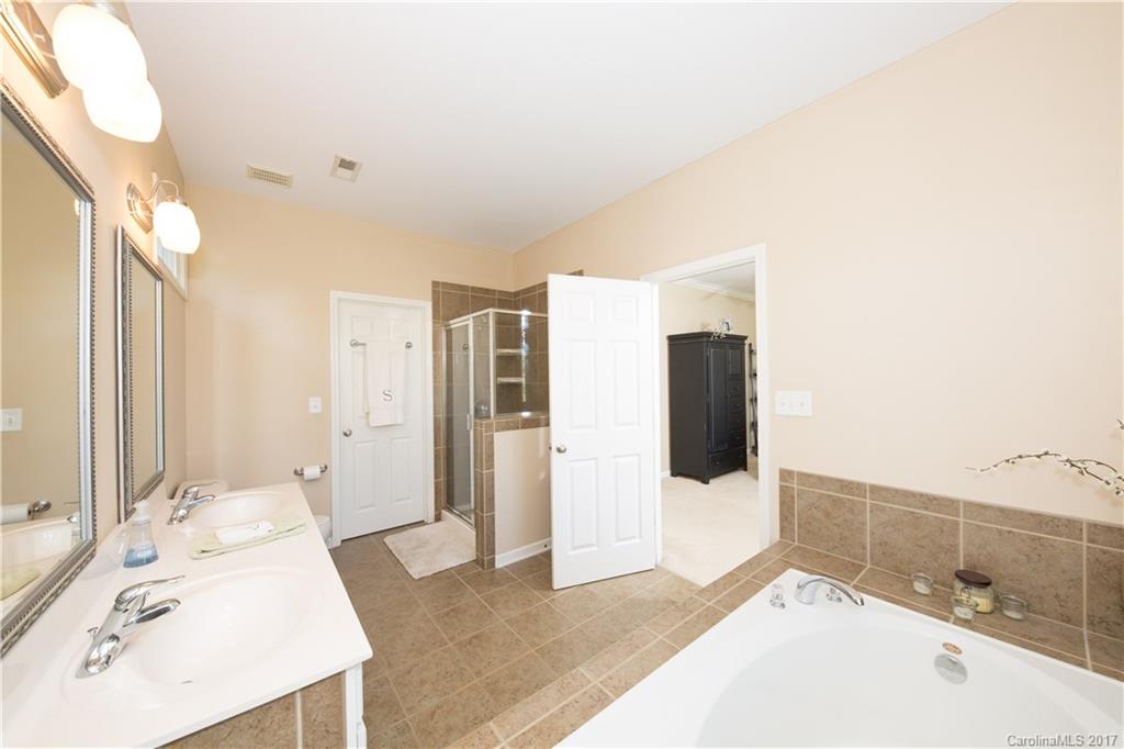 607 Caspar Way Fort Mill, SC 29708 - Photo 18 of 24 a en suite bathroom with a sink and mirror