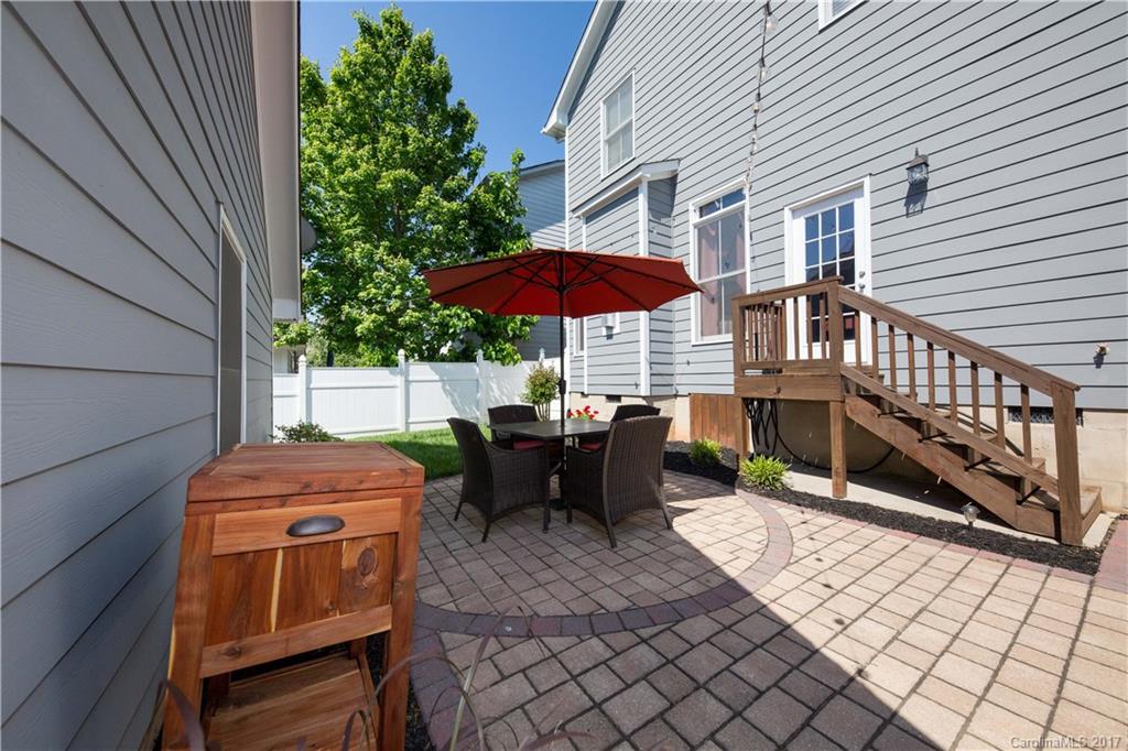 607 Caspar Way Fort Mill, SC 29708 - Photo 23 of 24 a view of a patio with a table and chairs under an umbrella