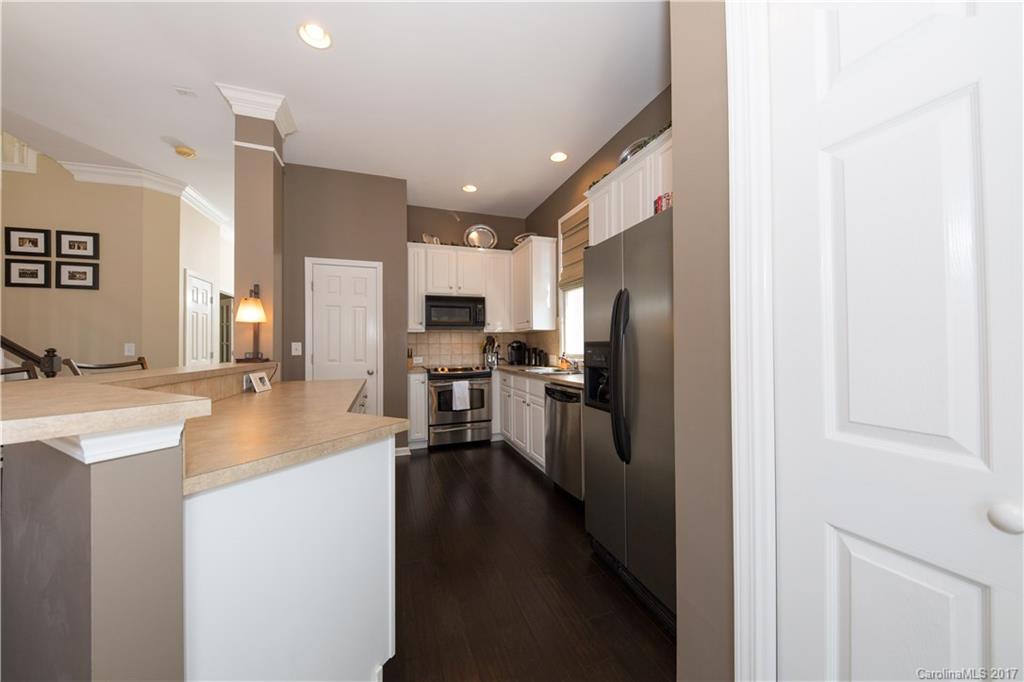 607 Caspar Way Fort Mill, SC 29708 - Photo 5 of 24 a kitchen with stainless steel appliances a refrigerator sink stove microwave and cabinets
