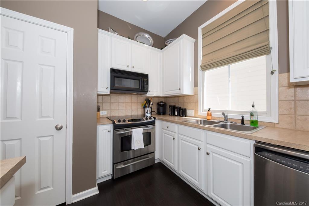 607 Caspar Way Fort Mill, SC 29708 - Photo 8 of 24 a kitchen with a sink cabinets stainless steel appliances and a window