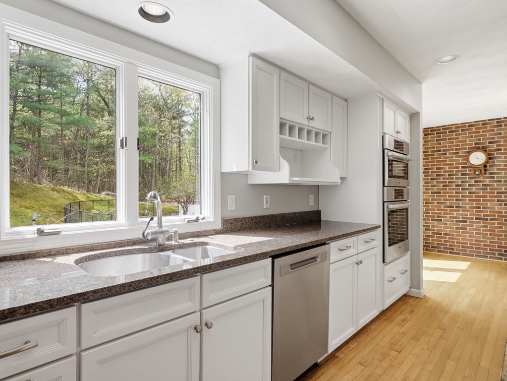 10 Hawk Ridge Road Andover, MA 01810 - Photo 6 of 32 a kitchen with granite countertop a sink and a window