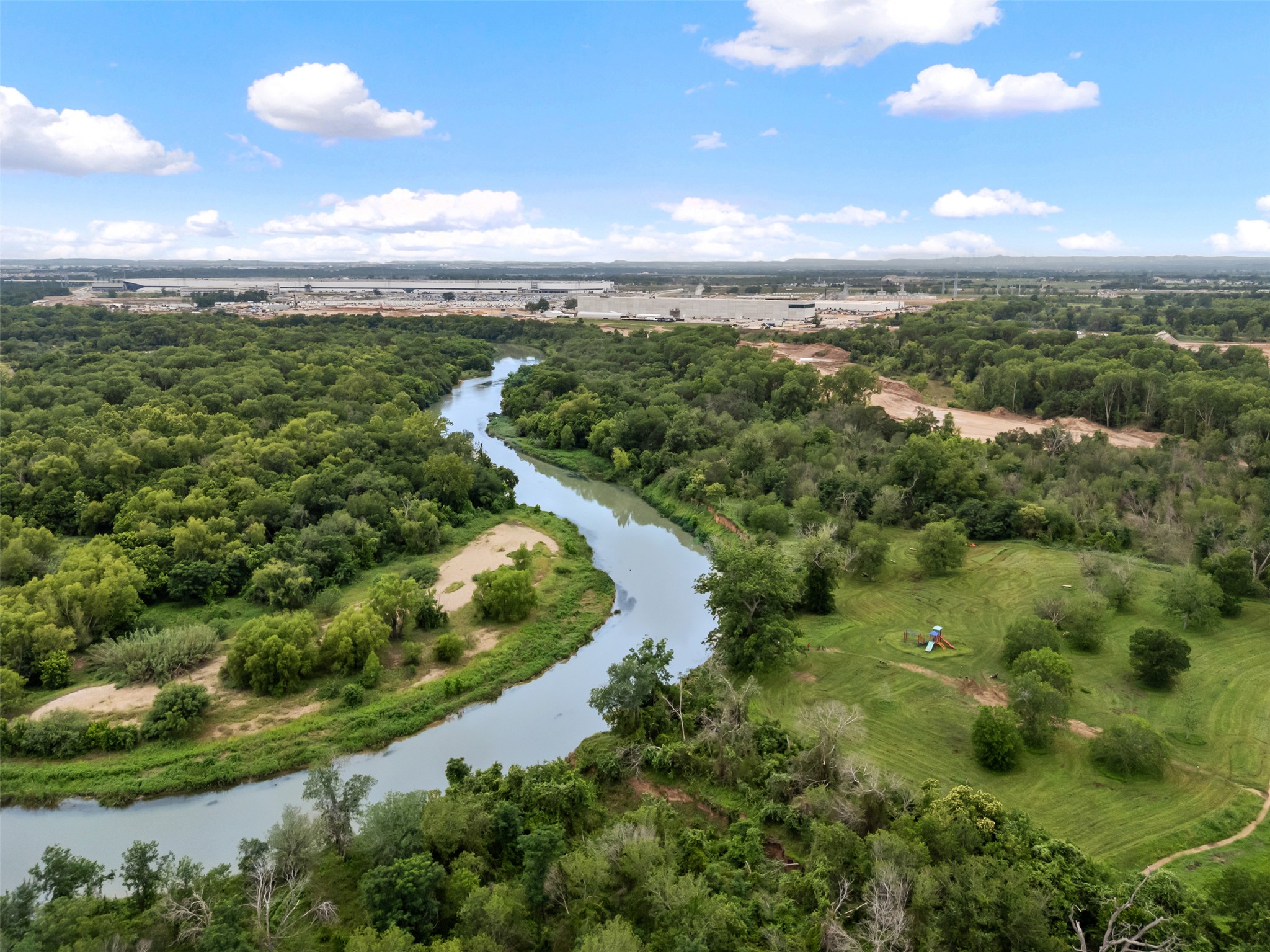14900 Retha Pass Austin, TX 78725 - Photo 26 of 39 Meandering river surrounded by dense, mature trees and natural landscape