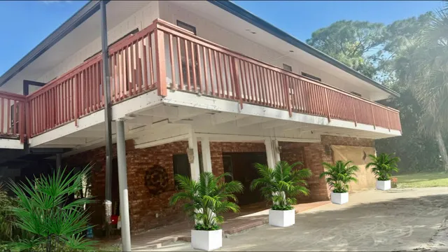 a view of a house with potted plants