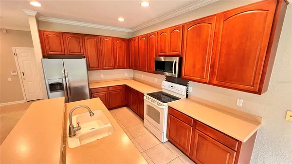 a kitchen with stainless steel appliances a refrigerator and a sink