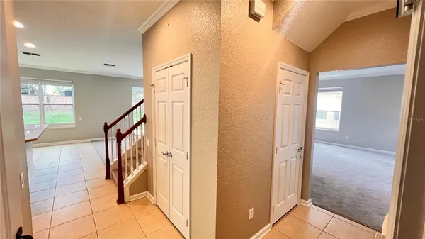 a view of a hallway with wooden floor and staircase