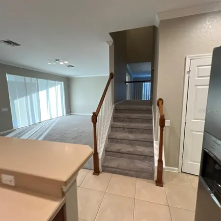 a view of a livingroom with furniture and stairs