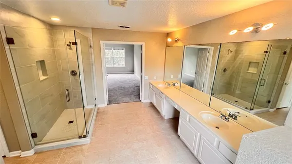 a bathroom with a double vanity sink and a mirror