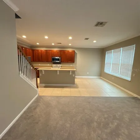 a view of kitchen with refrigerator sink and wooden floor
