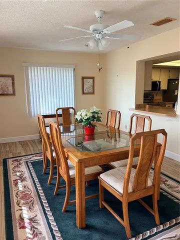 a dining room with furniture and window