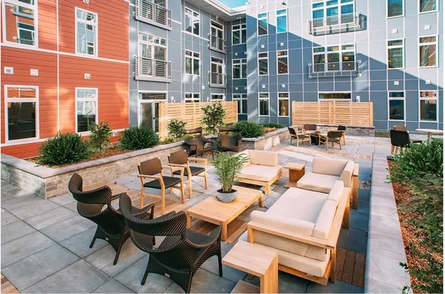 a view of a patio with table and chairs and potted plants