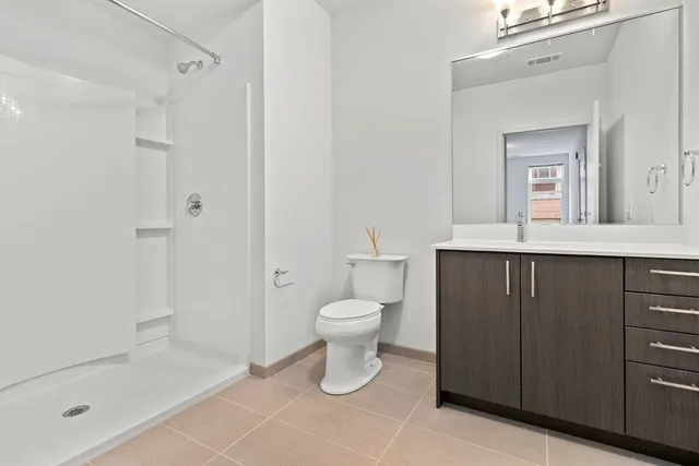 a bathroom with a toilet a sink and shower