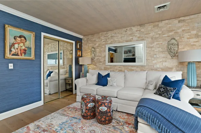 a living room with furniture and painting on the wall