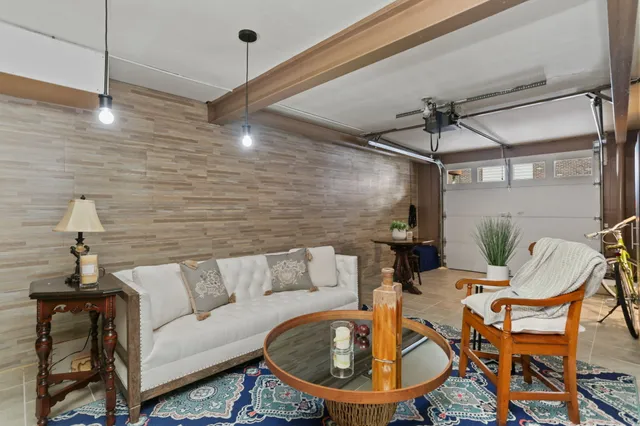 a living room with a couch and a chandelier