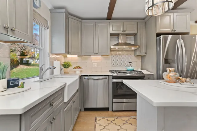 a kitchen with stainless steel appliances a sink stove and refrigerator