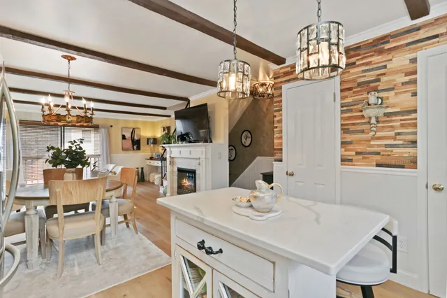 a view of a dining room with furniture and a chandelier