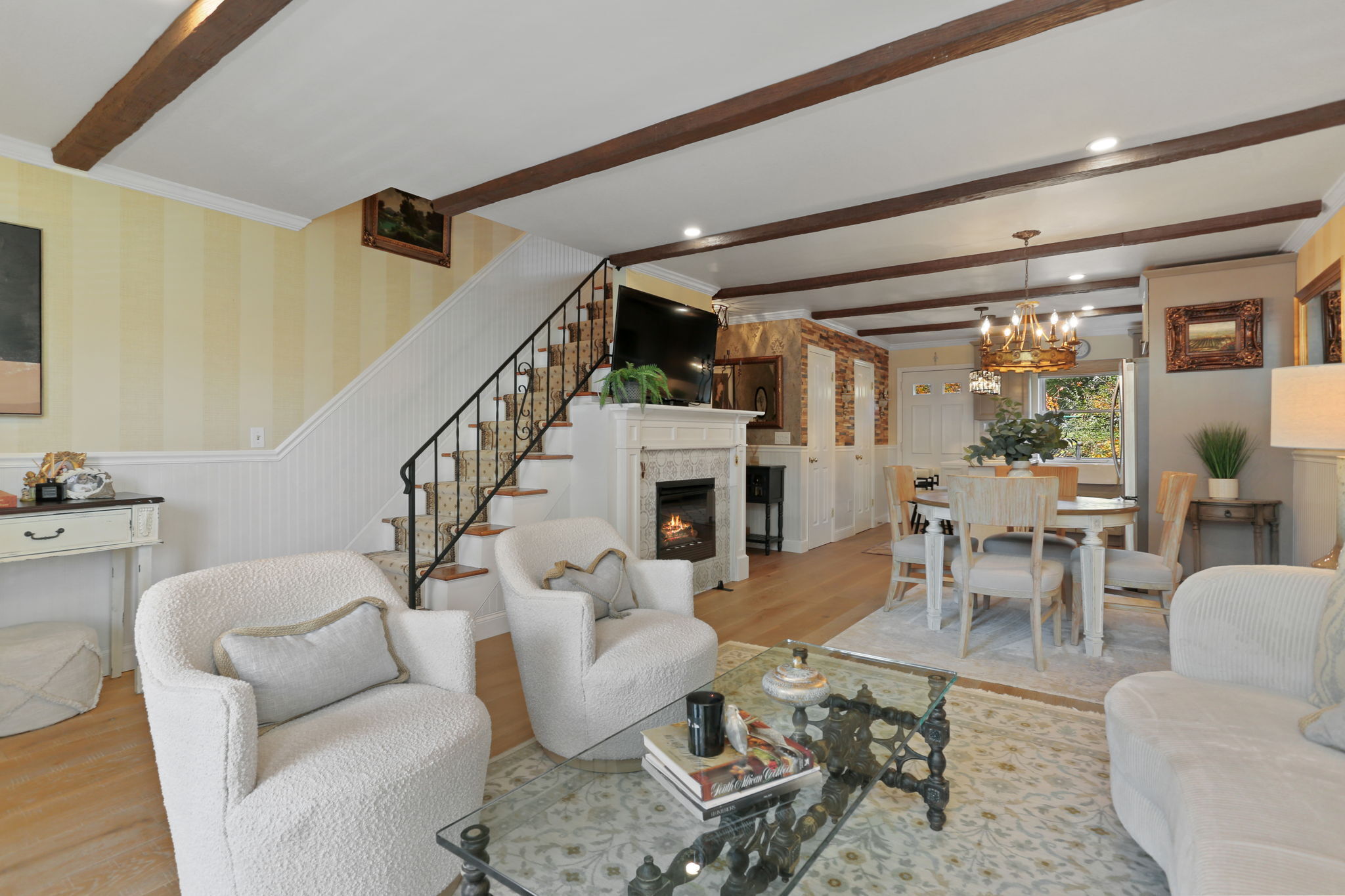 376 Knapps Highway, Unit 376 Fairfield, CT 06825 - Photo 8 of 22 a living room with furniture a fireplace and a floor to ceiling window