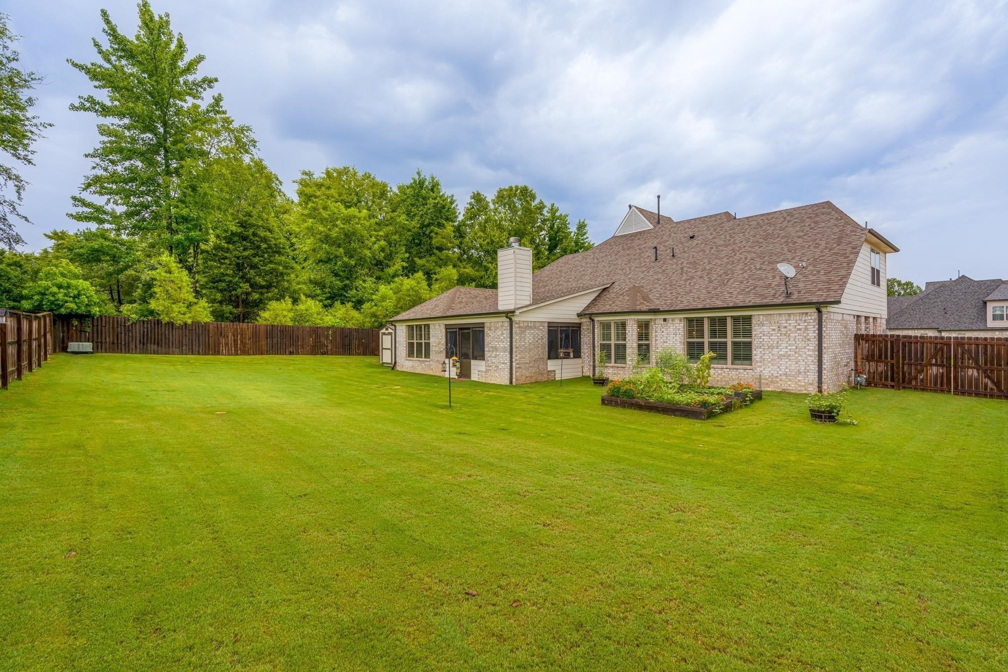 1217 Pilgrim Ridge Road Collierville, TN 38017 - Photo 33 of 33 Back of house with a fenced backyard, brick siding, a chimney, and roof with shingles