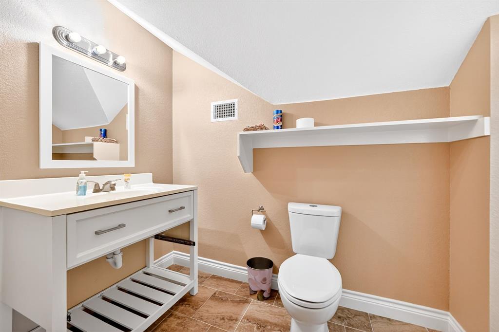 5230 Esquire Estates Road Mabank, TX 75156 - Photo 24 of 39 Bathroom featuring a white vanity with a rectangular sink, a framed mirror, and a wall-mounted light fixture