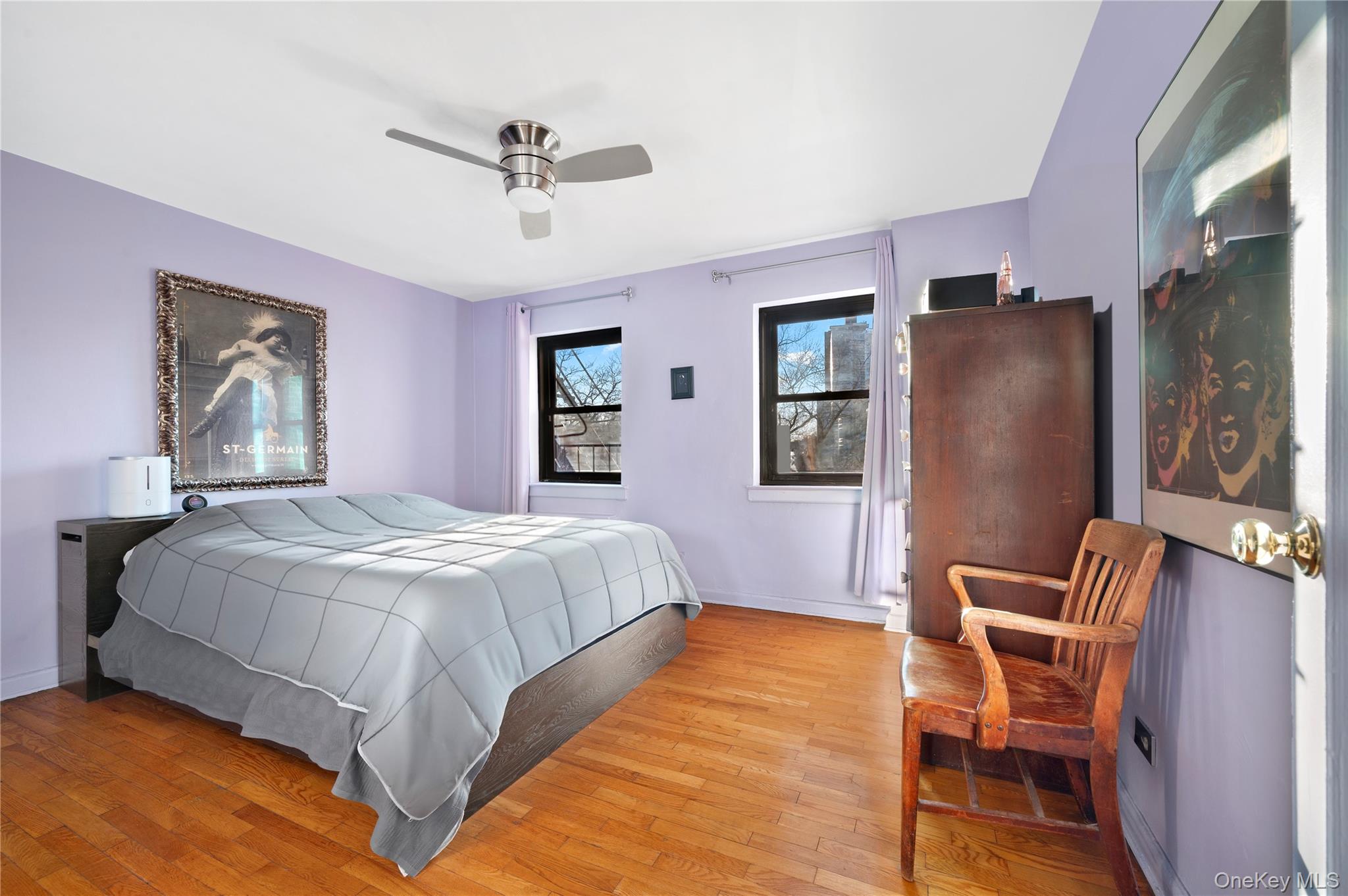 82-35 134th Street, Unit 3G Queens, NY 11435 - Photo 4 of 7 a bed room with a bed and a chair