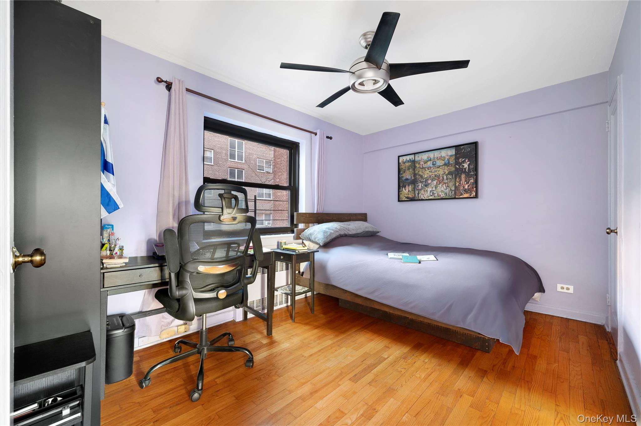 82-35 134th Street, Unit 3G Queens, NY 11435 - Photo 5 of 7 a bedroom with a bed and a table
