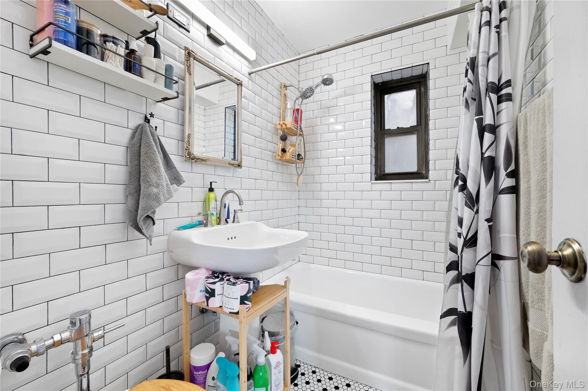 82-35 134th Street, Unit 3G Queens, NY 11435 - Photo 6 of 7 a bathroom with a sink a bathtub and shower