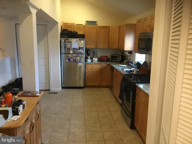 a kitchen with a refrigerator stove and a sink