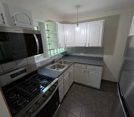 a kitchen with a stove and a sink