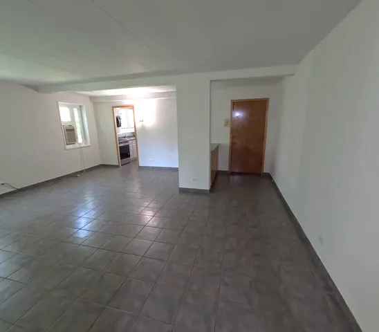 an empty room with windows and entrance