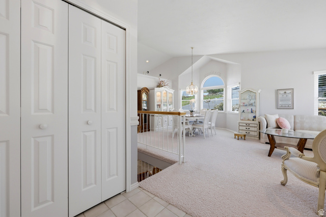 3766 Cardiff Circle Bountiful, UT 84010 - Photo 5 of 46 Vaulted ceiling living area featuring multiple windows, including a prominent arched window, and a chandelier-style light fixture