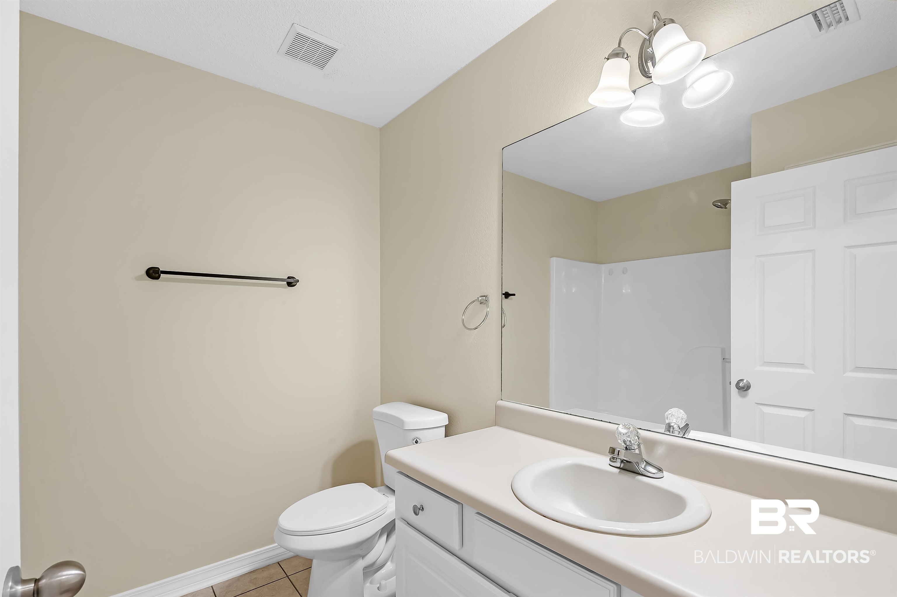 12443 Venice Boulevard Foley, AL 36535 - Photo 51 of 59 Bathroom featuring tile patterned flooring, walk in shower, toilet, a notable chandelier, and vanity