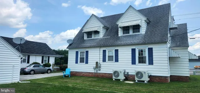a front view of house with yard and outdoor seating