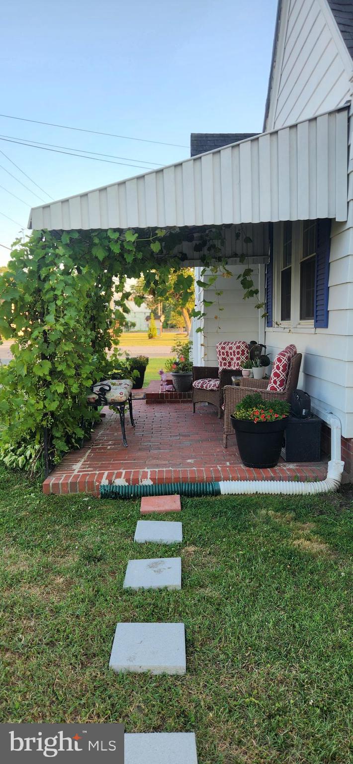 2001 Rhodesdale Vienna Vienna, MD 21869 - Photo 14 of 39 a front view of a house with a garden and swimming pool