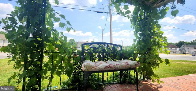 a view of a balcony with a table and chairs